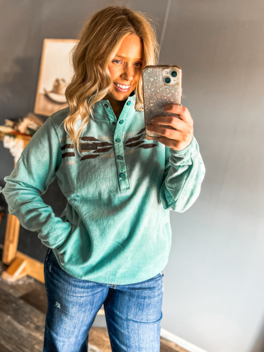 Woman’s turquoise fleece pullover